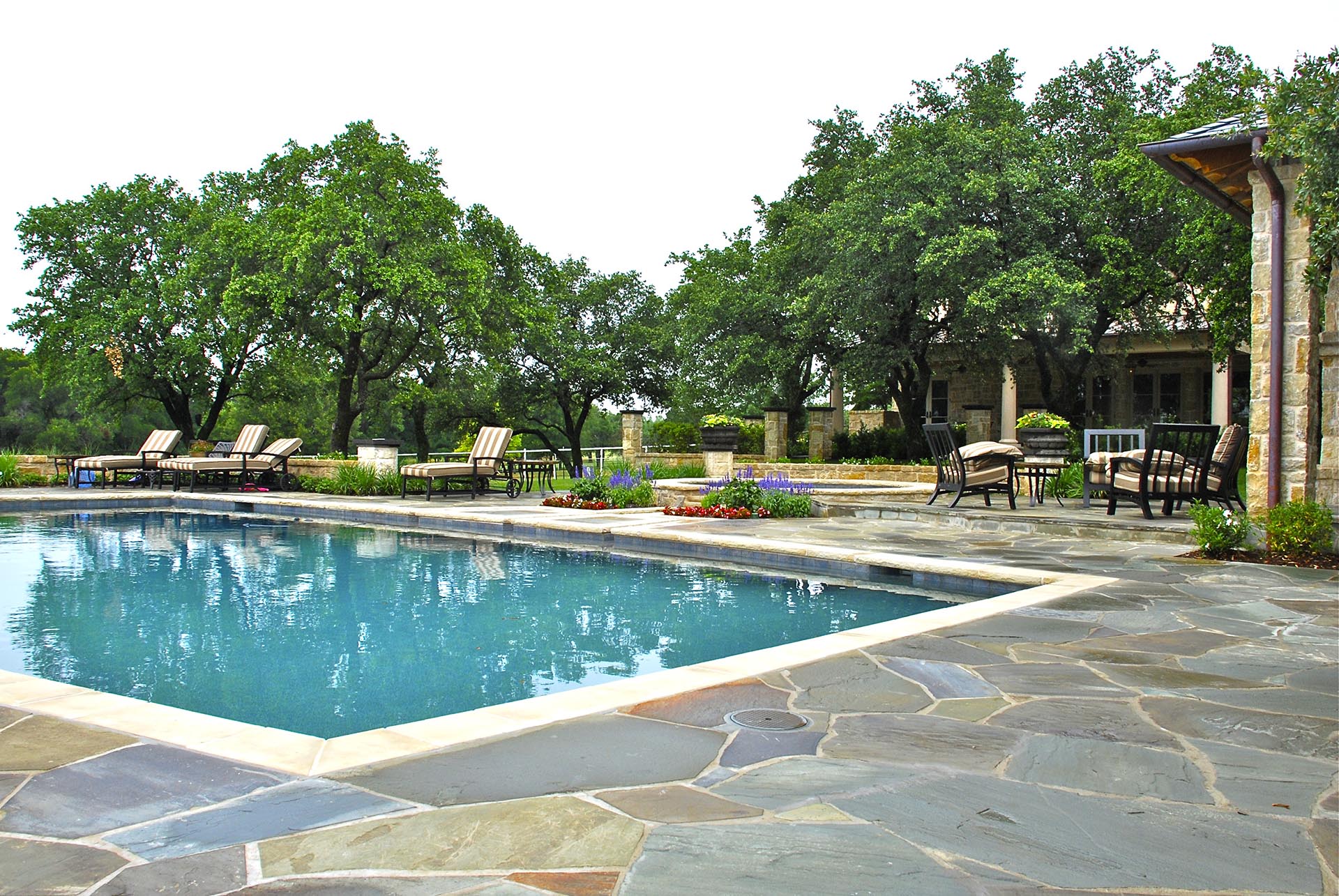 French Country estate pool flagstone deck in Dallas by landscape architect