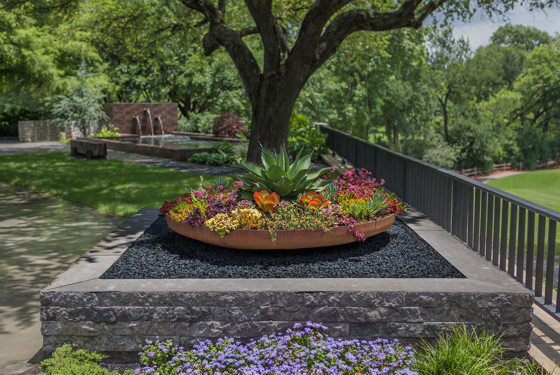 Organic modern landscape renovation with metal planters in Dallas